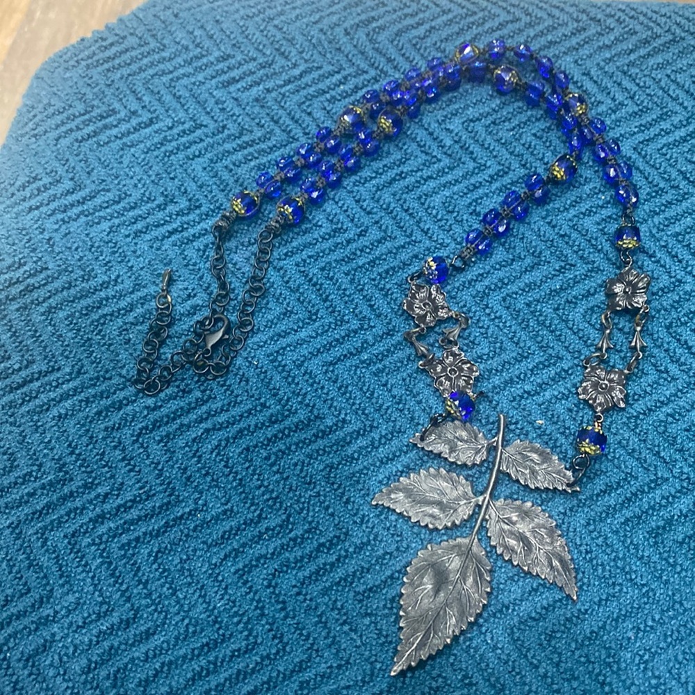 Necklace, with leaf, and flower& blue beads.